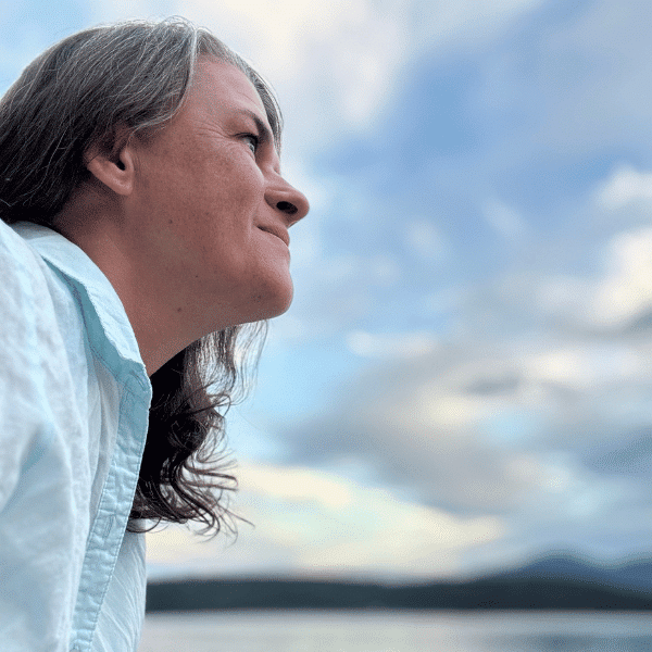 Kasia Rachfall standing in a forest path, somatic practitioner and creative healing guide in Kelowna.
